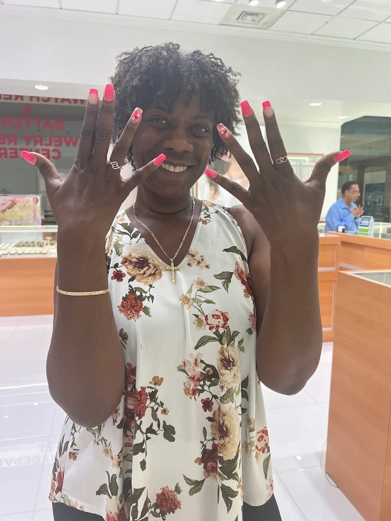 A customer showing her new rings and bracelet at Atlanta Jewelers