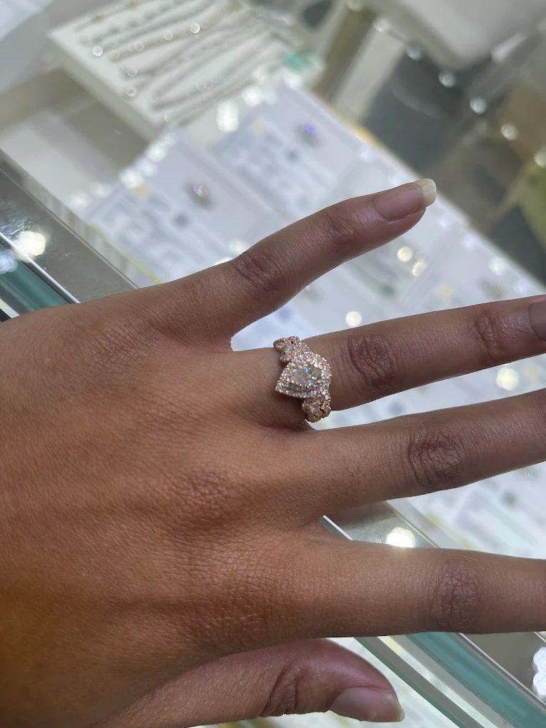 Rose gold heart-shaped diamond ring on a hand