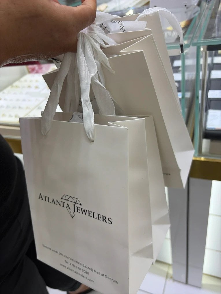 A customer holding Atlanta Jewelers shopping bags inside the store at the Mall of Georgia