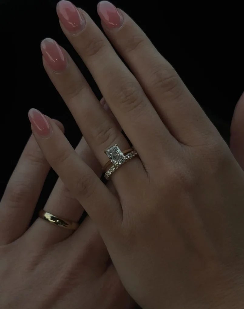 Lab diamond engagement ring and band on a hand